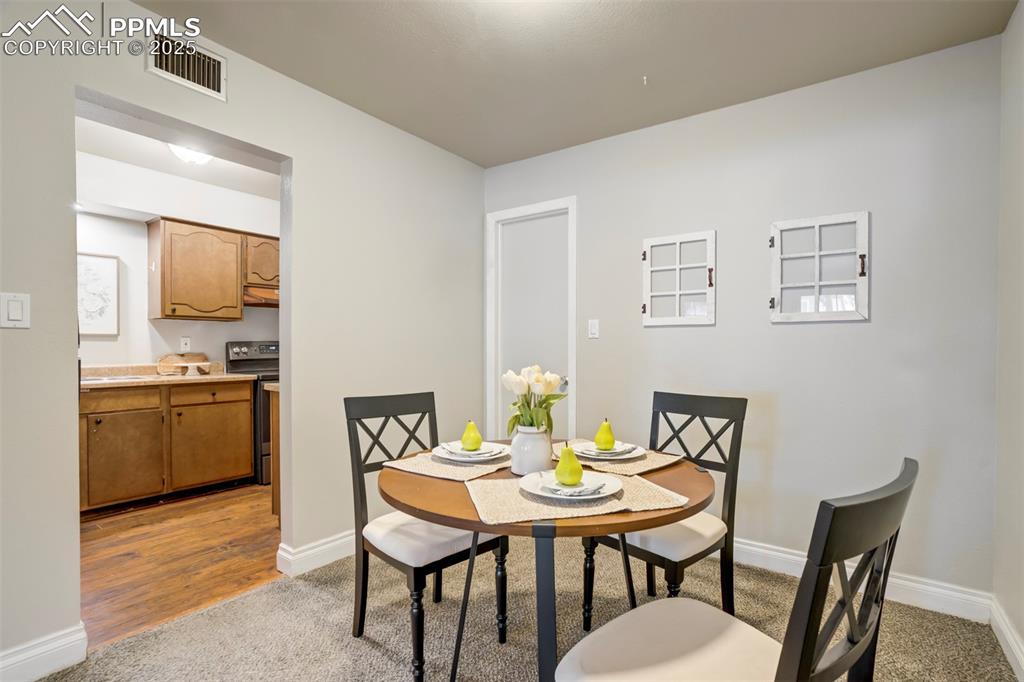 2902 Airport Road, Unit 116 Colorado Springs, CO 80910 - Photo 15 of 32 a view of a dining room with furniture