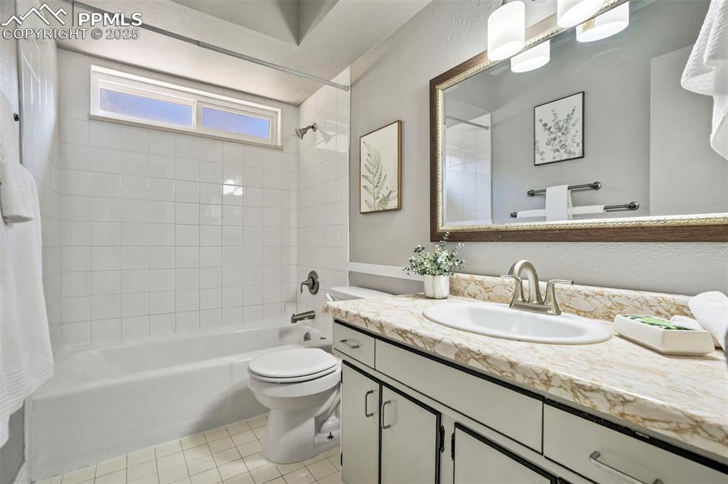 2902 Airport Road, Unit 116 Colorado Springs, CO 80910 - Photo 8 of 32 a bathroom with a granite countertop sink a toilet and bathtub