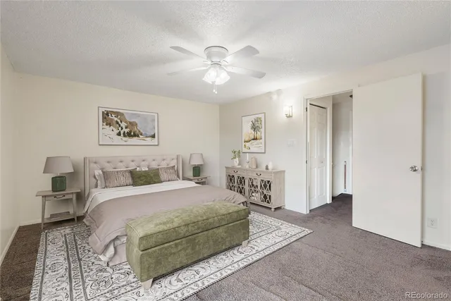 a spacious bedroom with a bed and a chandelier