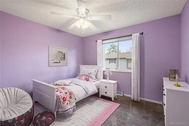 an empty room with a ceiling fan and a window