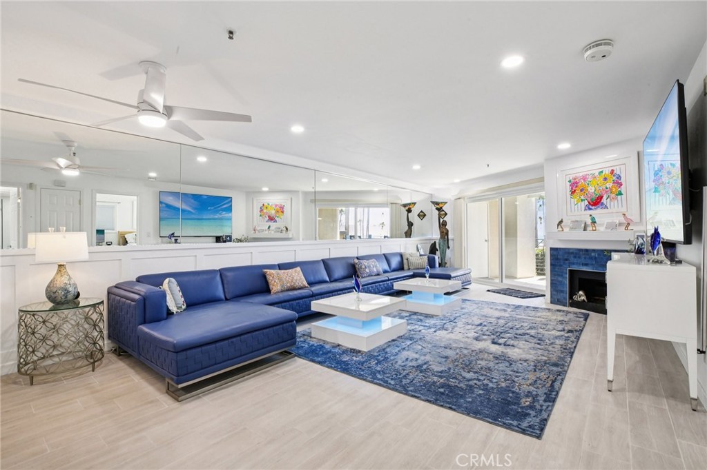 200 Pacific Coast Highway, Unit 130 Huntington Beach, CA 92648 - Photo 11 of 36 a living room with furniture and a fireplace