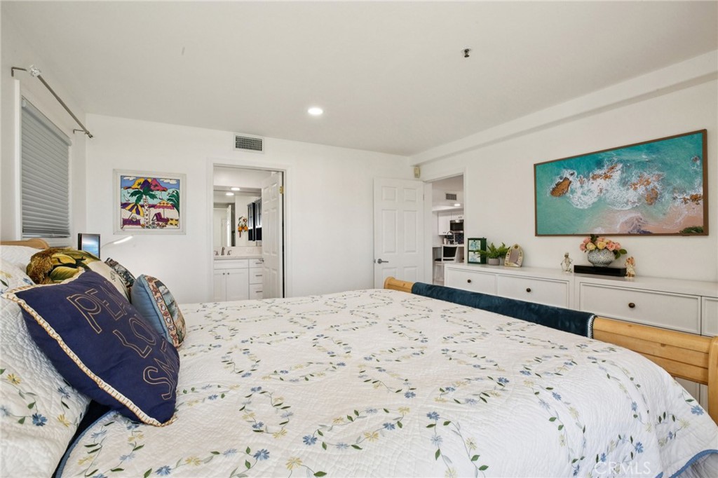 200 Pacific Coast Highway, Unit 130 Huntington Beach, CA 92648 - Photo 17 of 36 a large bedroom with a bed and glass wall