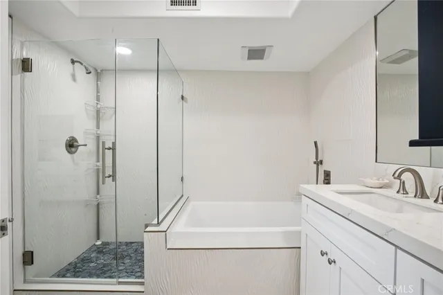 a bathroom with a shower sink and mirror