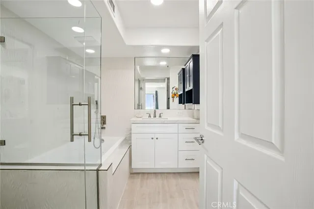 a bathroom with a shower sink and mirror