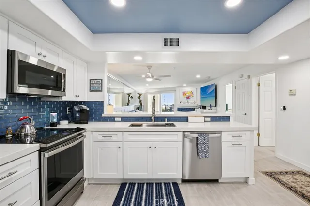 a kitchen with stainless steel appliances granite countertop a sink and stove top oven