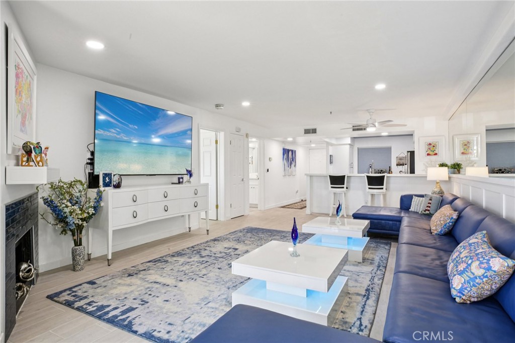 200 Pacific Coast Highway, Unit 130 Huntington Beach, CA 92648 - Photo 10 of 36 a living room with furniture and a flat screen tv
