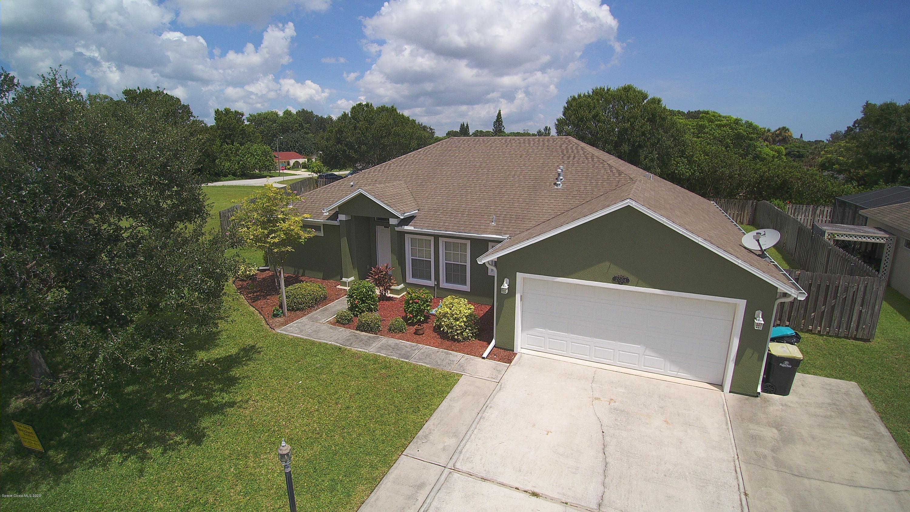 2004 Gloria Circle Palm Bay, FL 32905 - Photo 1 of 36 a aerial view of a house with a yard