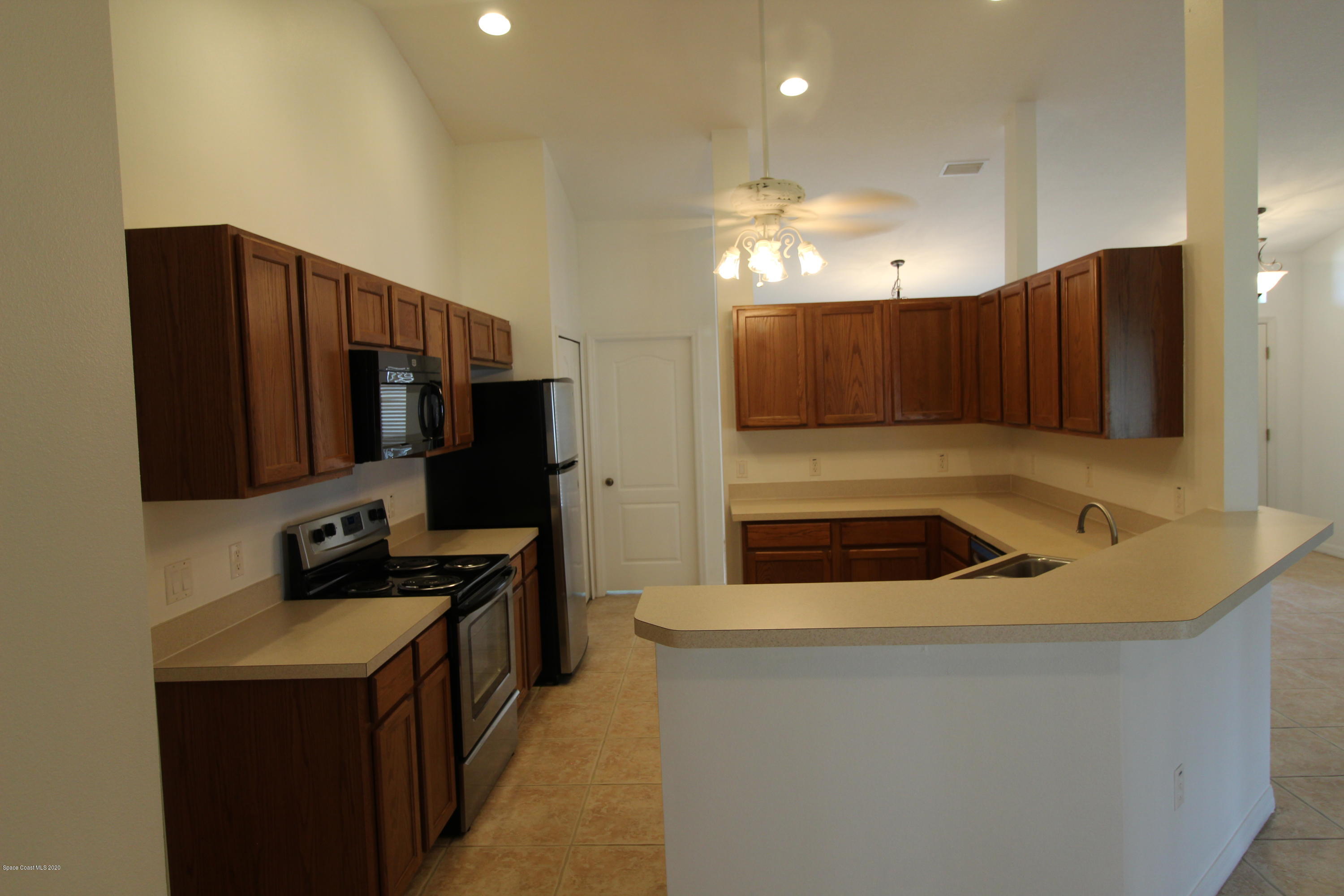 2004 Gloria Circle Palm Bay, FL 32905 - Photo 12 of 36 a kitchen that has a sink and a stove in it