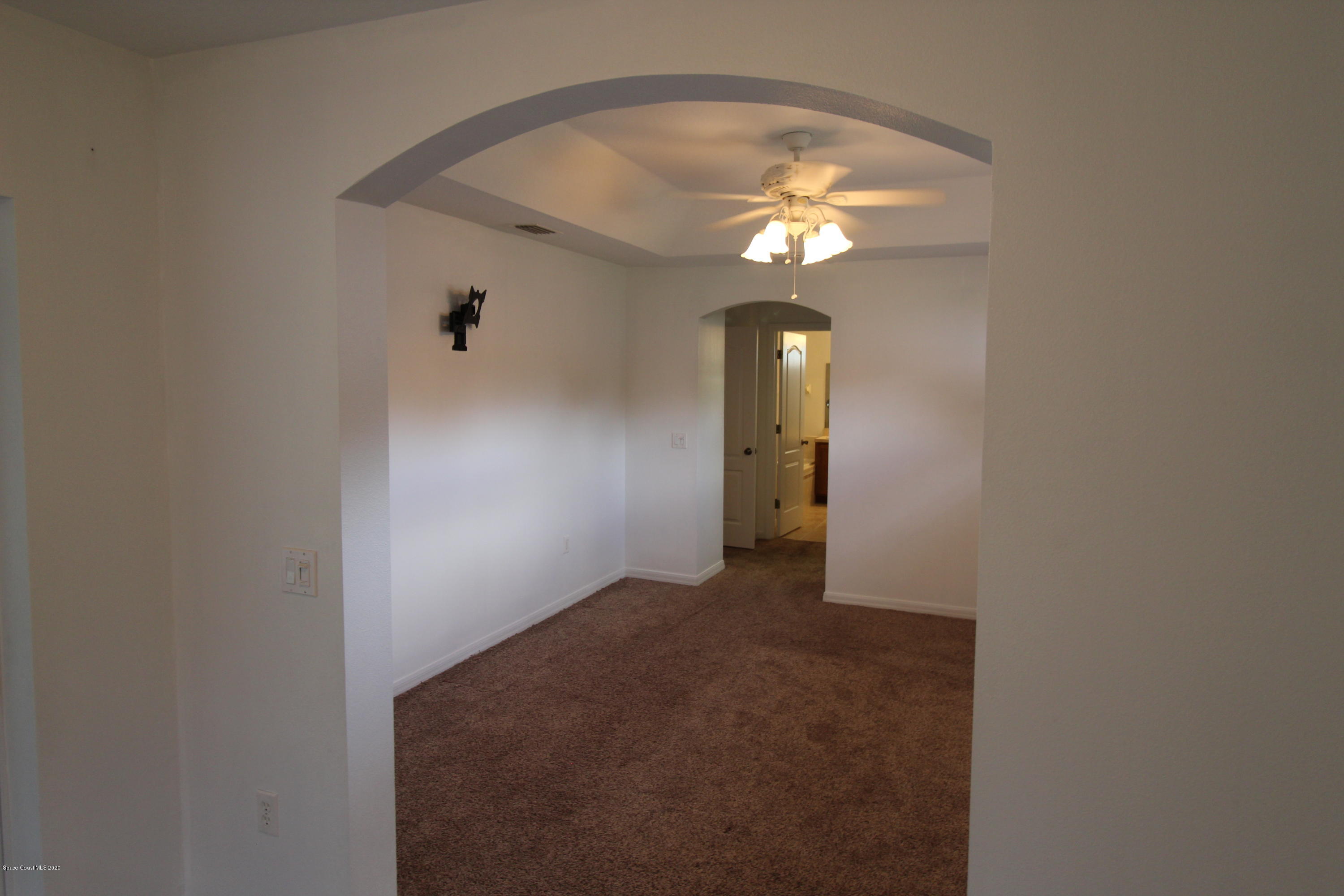 2004 Gloria Circle Palm Bay, FL 32905 - Photo 15 of 36 a view of a chandelier fan and fire place
