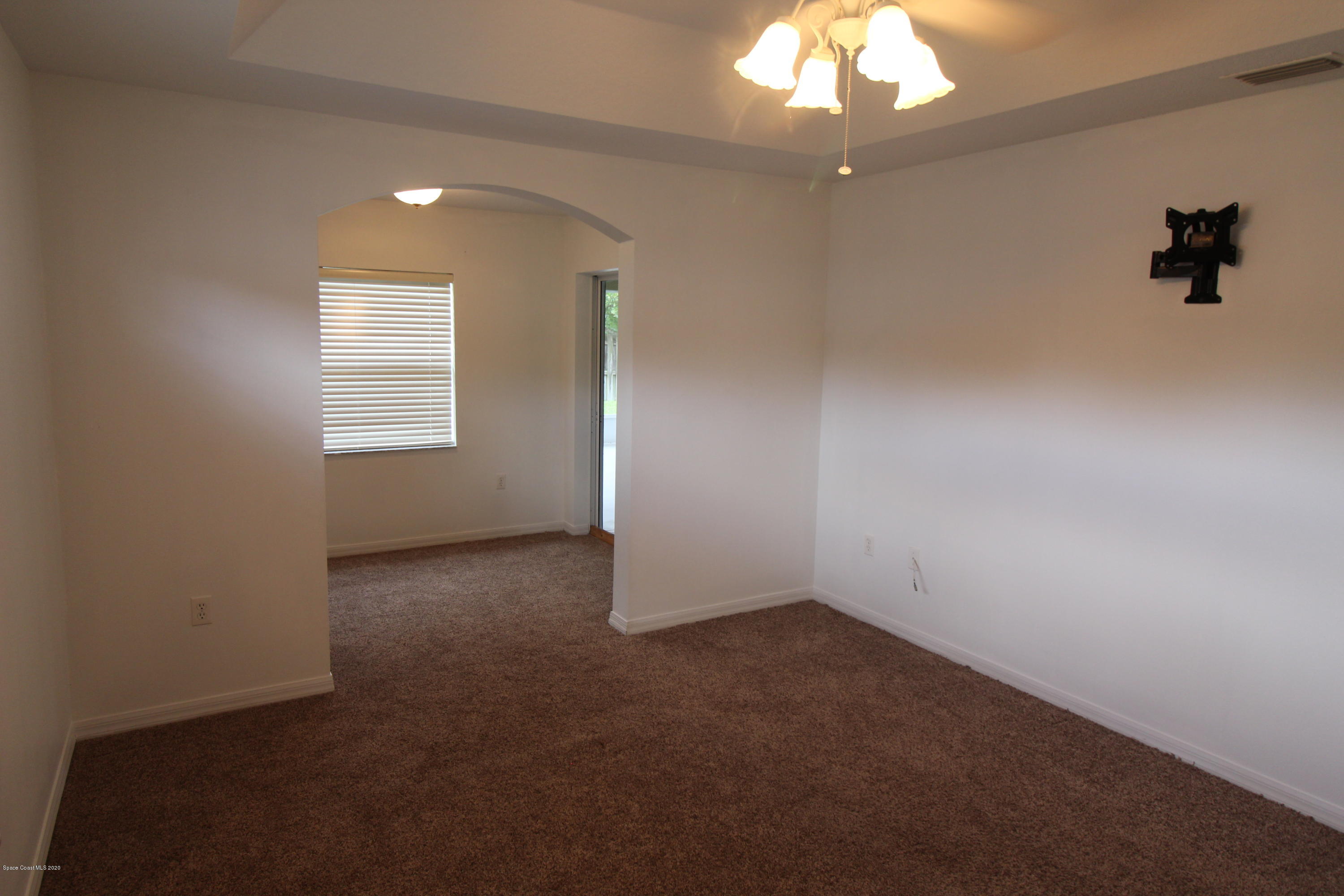 2004 Gloria Circle Palm Bay, FL 32905 - Photo 16 of 36 en empty room with windows and ceiling fan