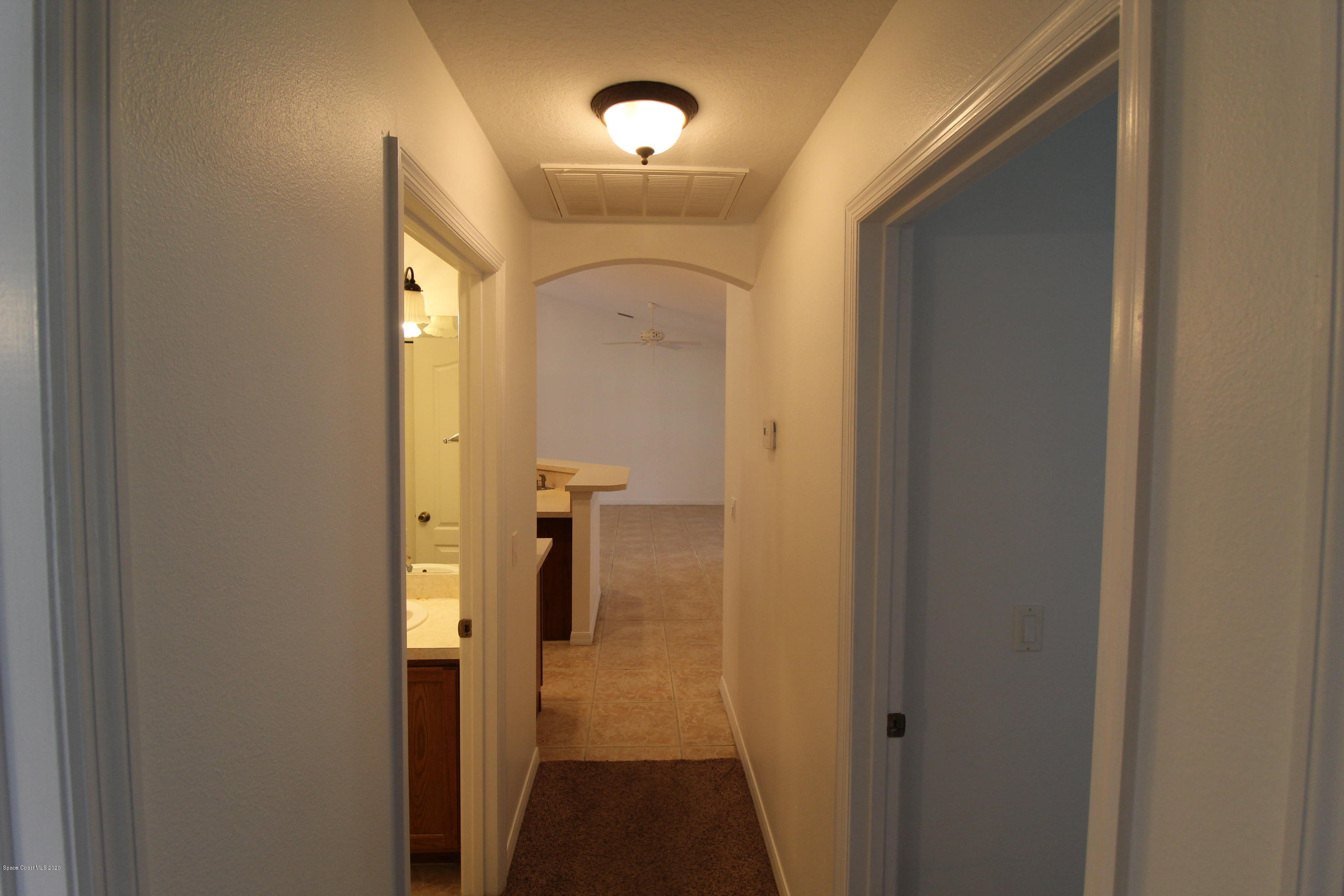 2004 Gloria Circle Palm Bay, FL 32905 - Photo 21 of 36 a view of a hallway with wooden floor
