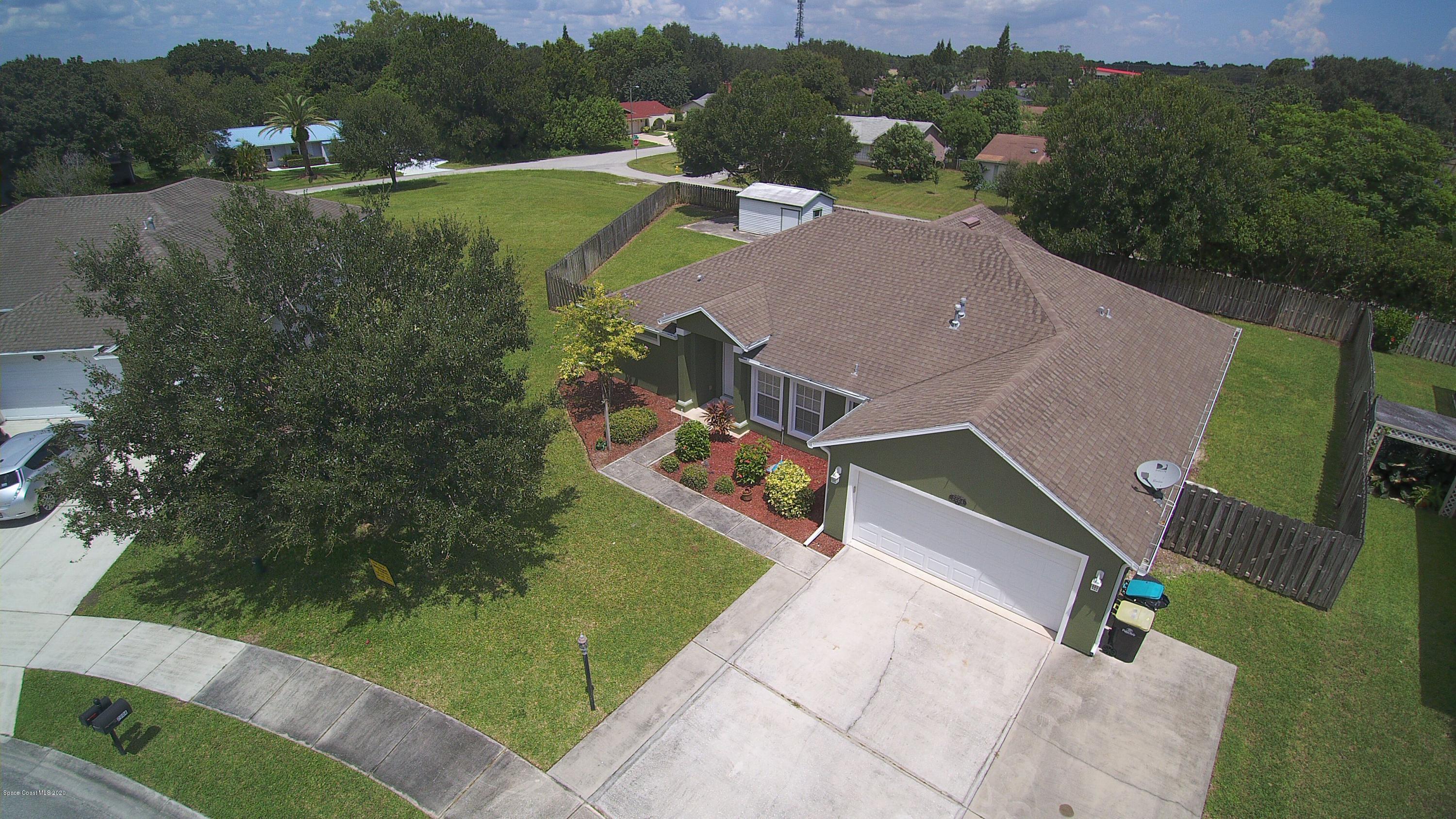 2004 Gloria Circle Palm Bay, FL 32905 - Photo 33 of 36 an aerial view of a house with a garden