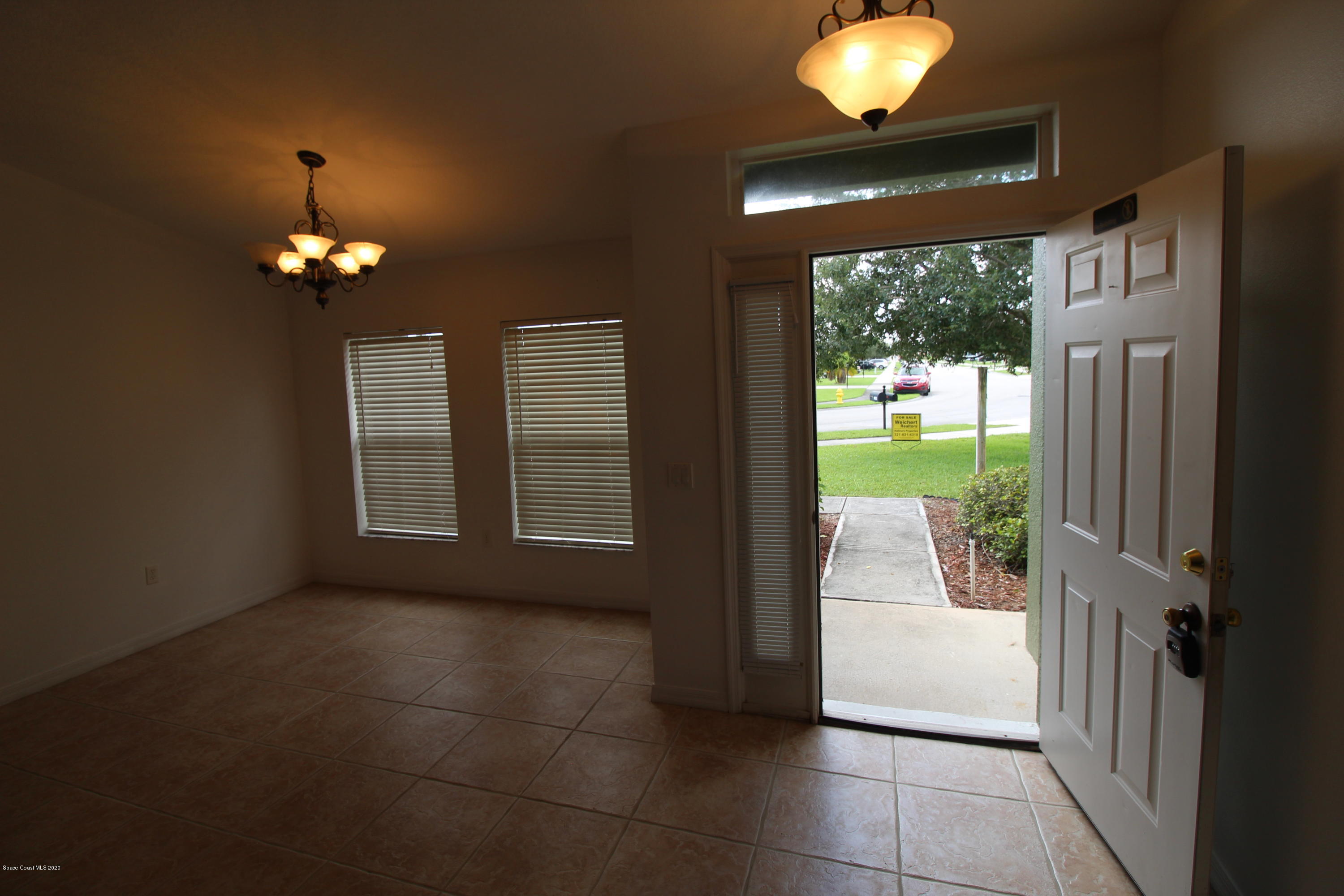 2004 Gloria Circle Palm Bay, FL 32905 - Photo 5 of 36 a view of a livingroom with furniture wooden floor and a chandelier