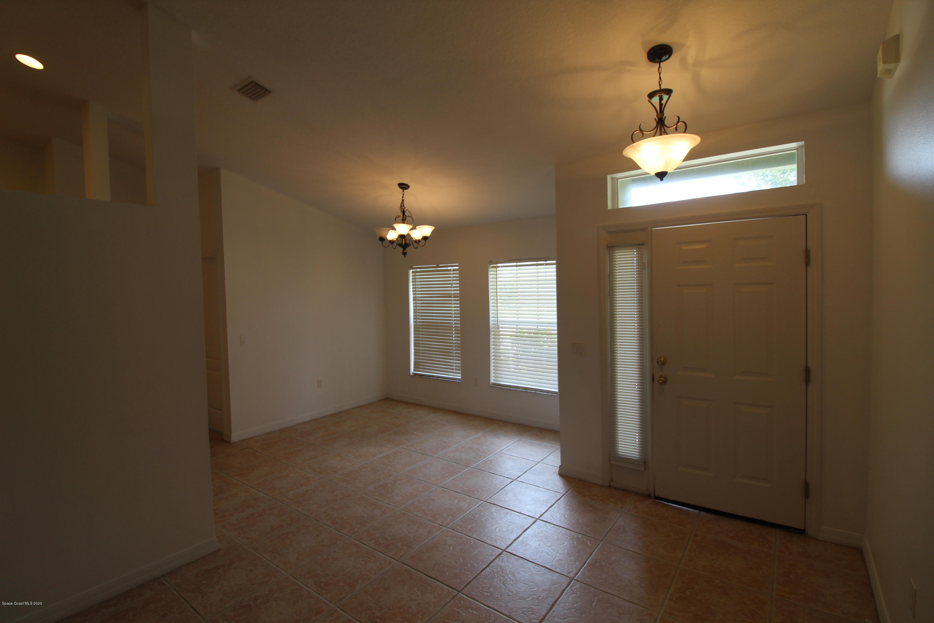 2004 Gloria Circle Palm Bay, FL 32905 - Photo 6 of 36 a view of a livingroom with a chandelier fan and windows