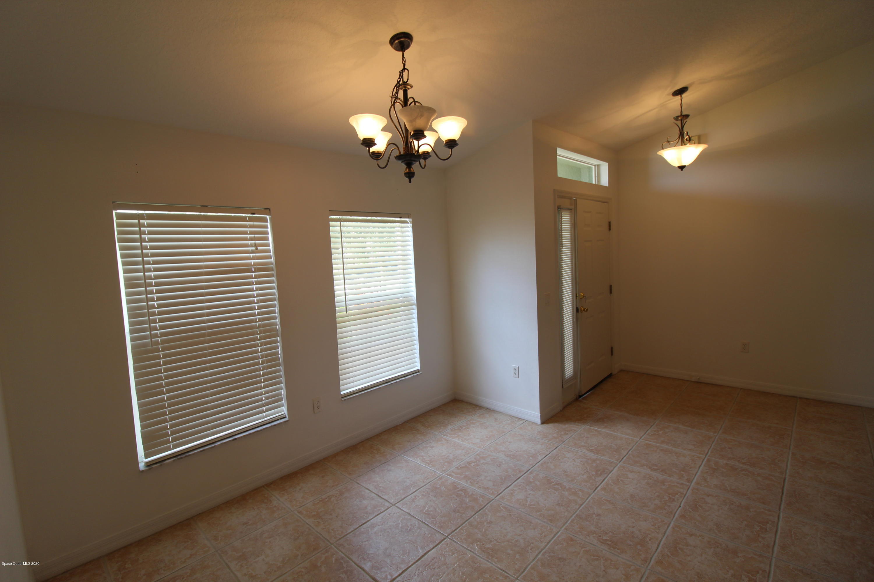 2004 Gloria Circle Palm Bay, FL 32905 - Photo 7 of 36 a view of a livingroom with a chandelier fan and windows