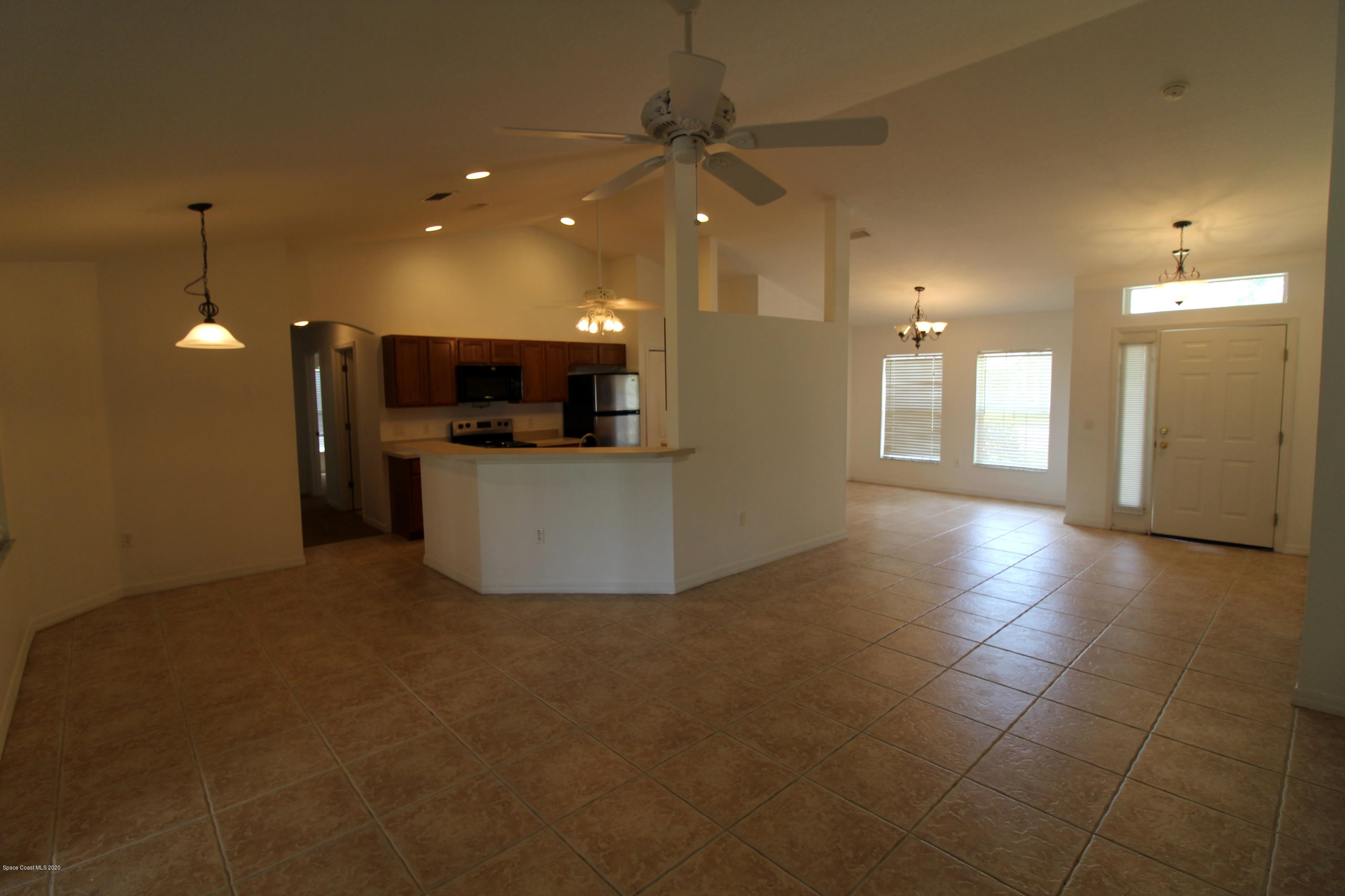 2004 Gloria Circle Palm Bay, FL 32905 - Photo 9 of 36 a view of a kitchen with a sink and a refrigerator