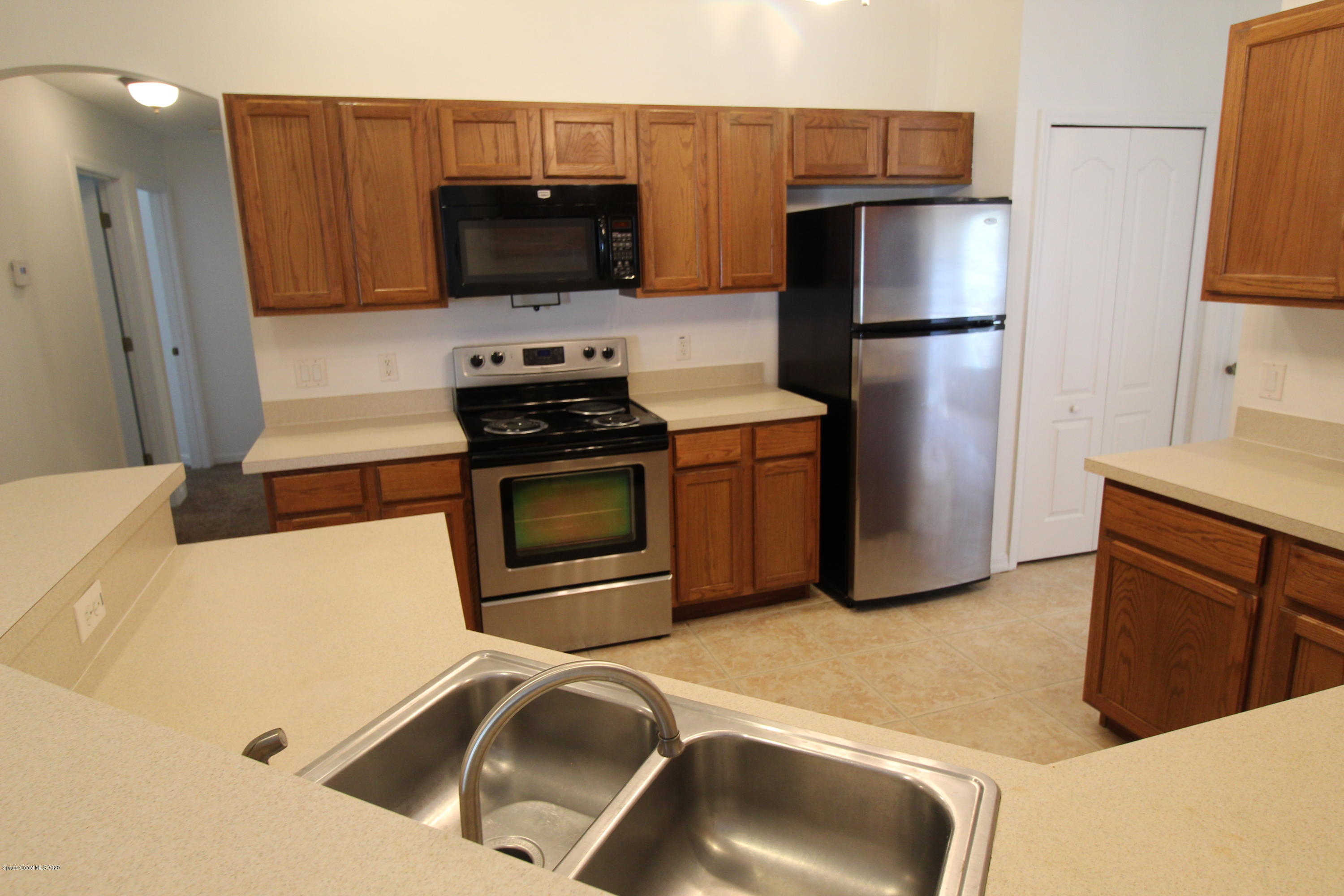 2004 Gloria Circle Palm Bay, FL 32905 - Photo 10 of 36 a kitchen with stainless steel appliances a stove a microwave and a refrigerator