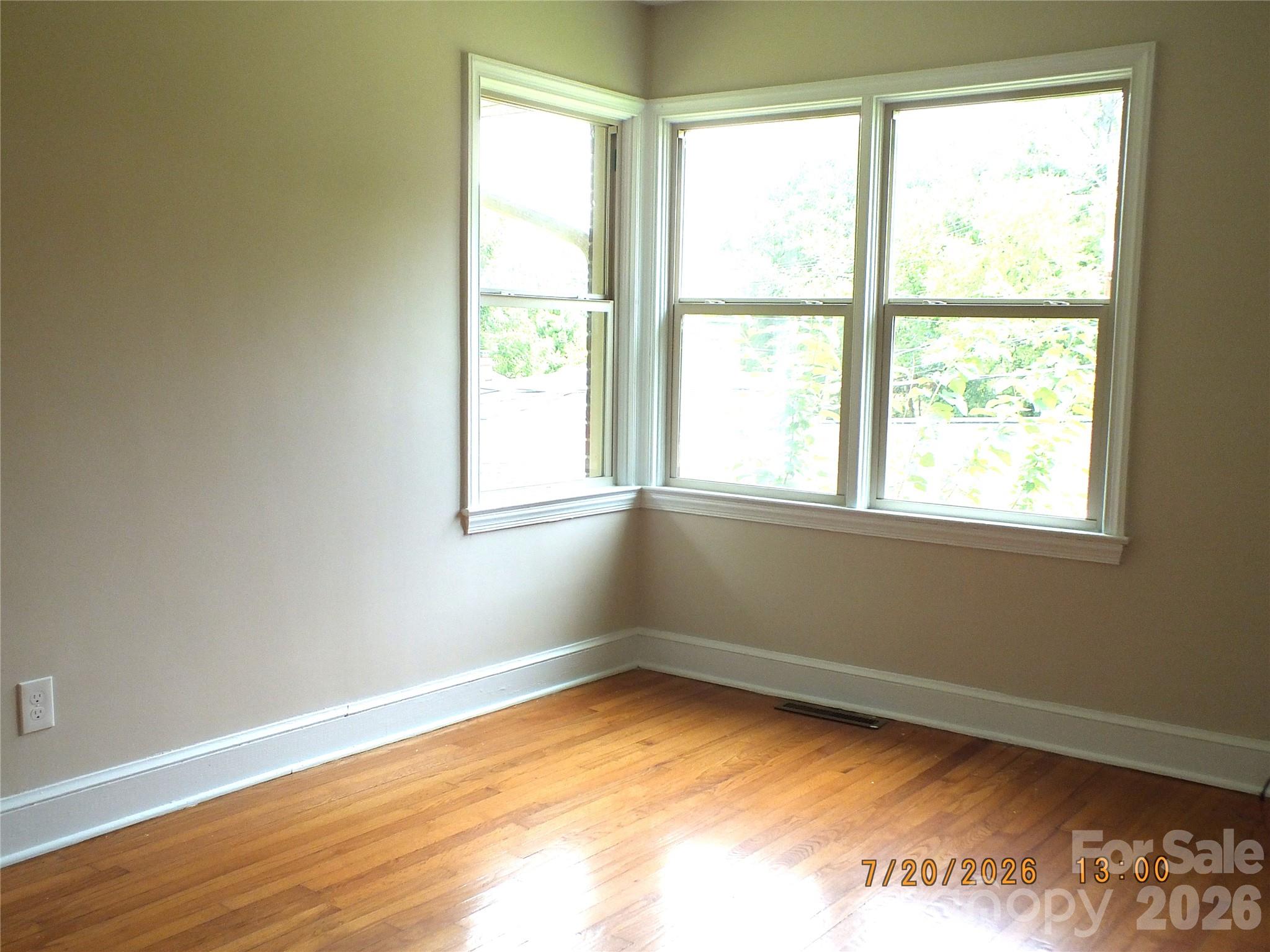 414 West Springs Street Lancaster, SC 29720 - Photo 12 of 22 a view of an empty room with wooden floor and a window