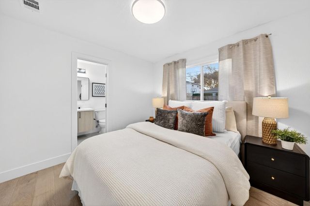 a bedroom with a bed and a lamp