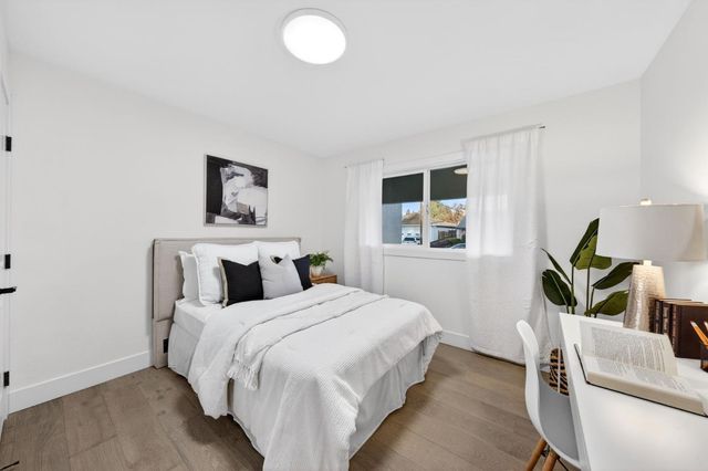 a bedroom with a bed and a couch