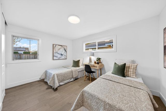 a bedroom with two beds and a window