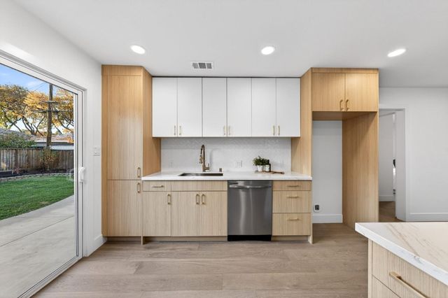 a kitchen with stainless steel appliances granite countertop a stove a refrigerator and a refrigerator