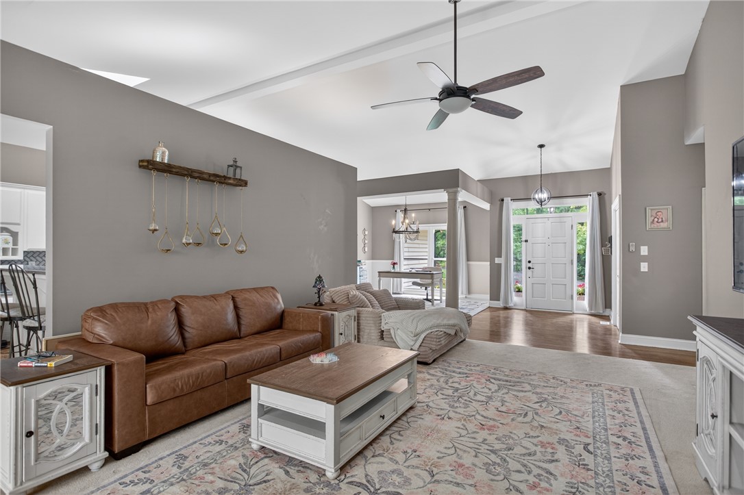 136 Loran Pointe Circle Seneca, SC 29672 - Photo 5 of 50 A well-lit great room features high ceilings and a welcoming entrance with warm hardwood flooring.