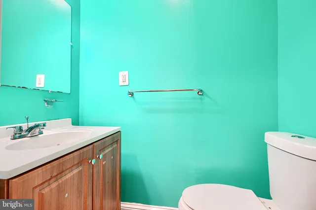 a bathroom with a sink a toilet and mirror