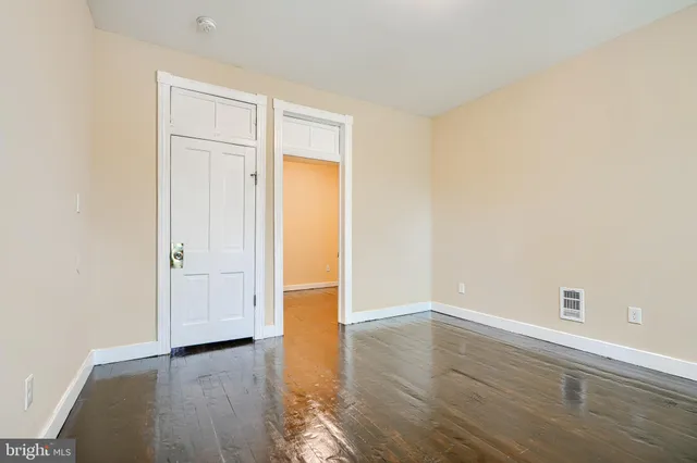 an empty room with wooden floor