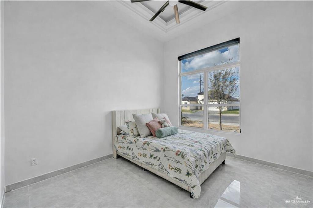 1105 Wesley Street Pharr, TX 78577 - Photo 12 of 17 a bedroom with a bed and window