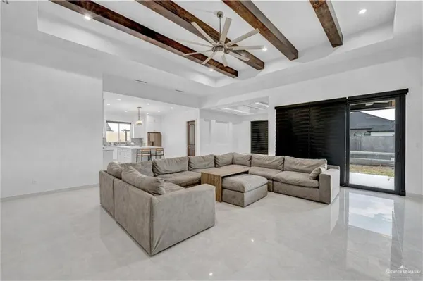 a living room with furniture and a ceiling fan