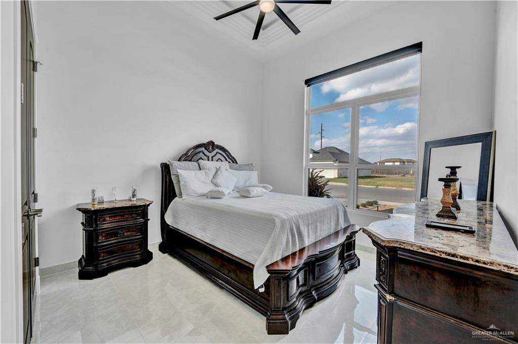 1105 Wesley Street Pharr, TX 78577 - Photo 10 of 17 a bedroom with a bed and large windows