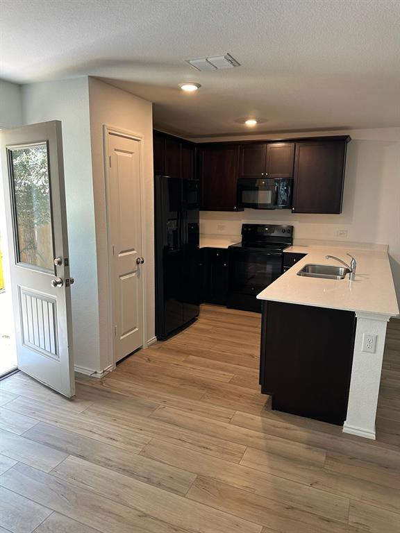 a kitchen with stainless steel appliances kitchen island granite countertop a stove top oven and sink