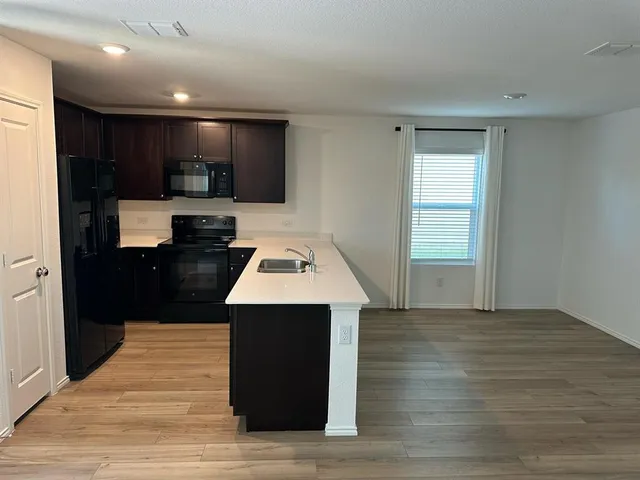 a kitchen with a sink and cabinets