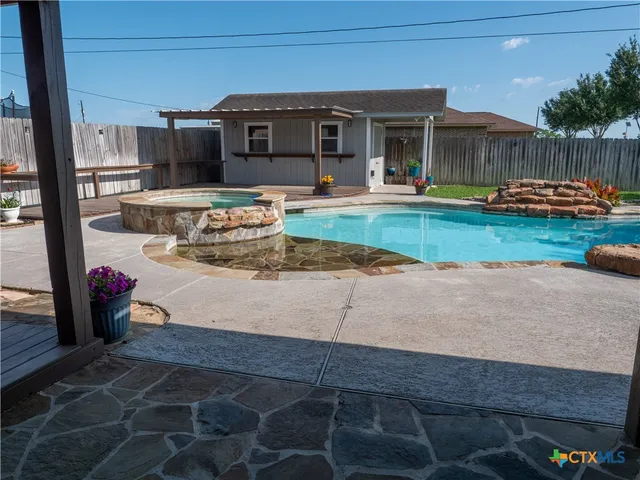 a view of a house with backyard and sitting area