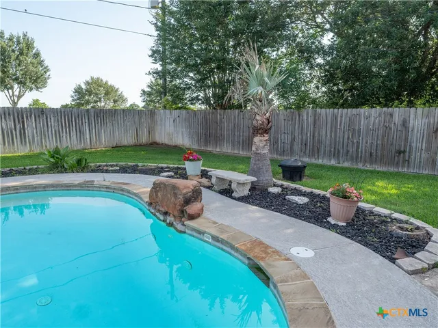 a garden with trees in the background