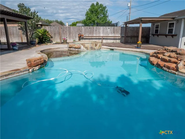 a view of a backyard with plants and patio