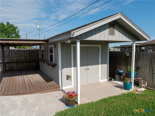 a view of a balcony with wooden floor and iron stairs