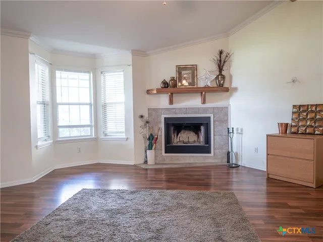 a view of a livingroom with a fireplace a window and a fireplace