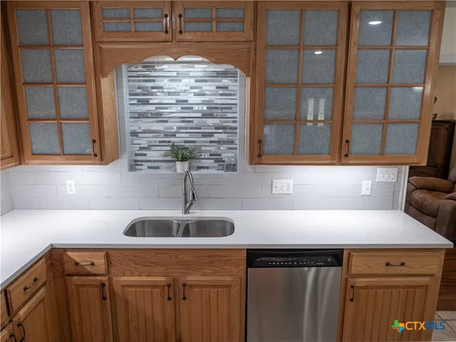 a kitchen with a sink and cabinets