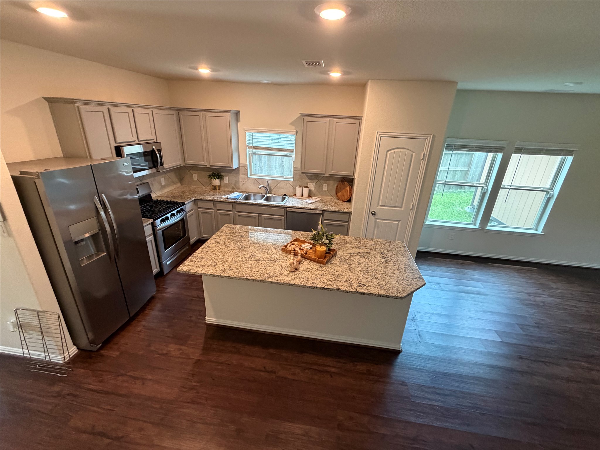 4706 Walnut Willow Ct Spring Spring, TX 77386 - Photo 14 of 17 a view of a kitchen with kitchen island wooden floor center island and stainless steel appliances
