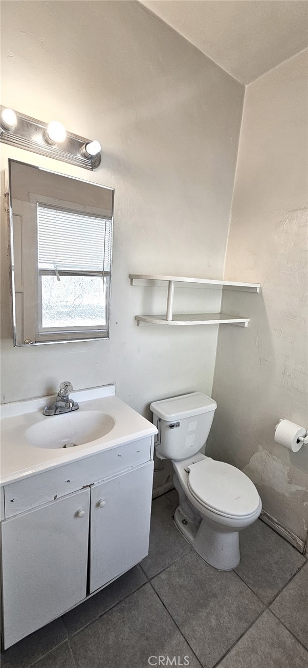 6555 Indian Cove Road Twentynine Palms, CA 92277 - Photo 12 of 14 a white toilet sitting next to a bathroom sink