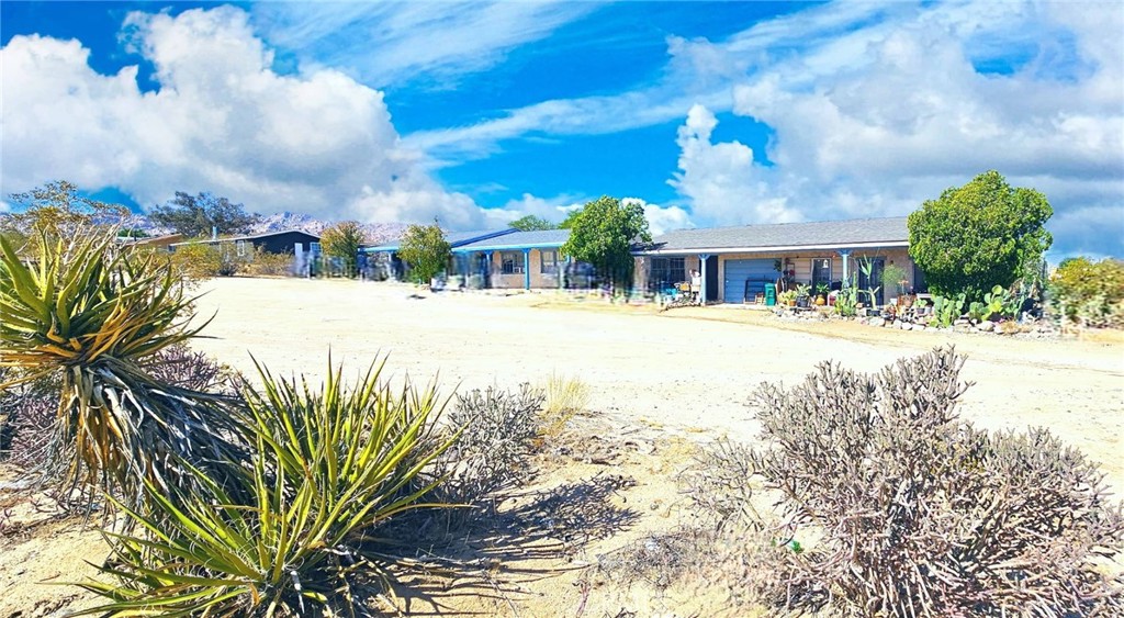 6555 Indian Cove Road Twentynine Palms, CA 92277 - Photo 4 of 14 a view of a street with a building in the background