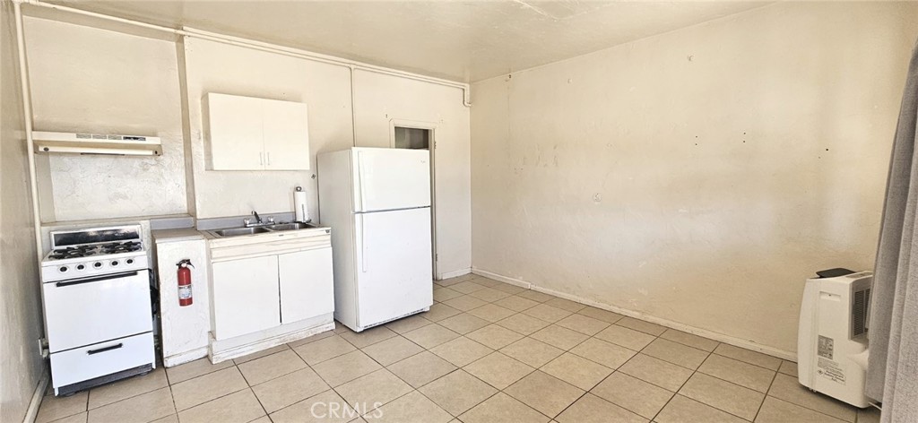 6555 Indian Cove Road Twentynine Palms, CA 92277 - Photo 7 of 14 a kitchen with white cabinets and white appliances