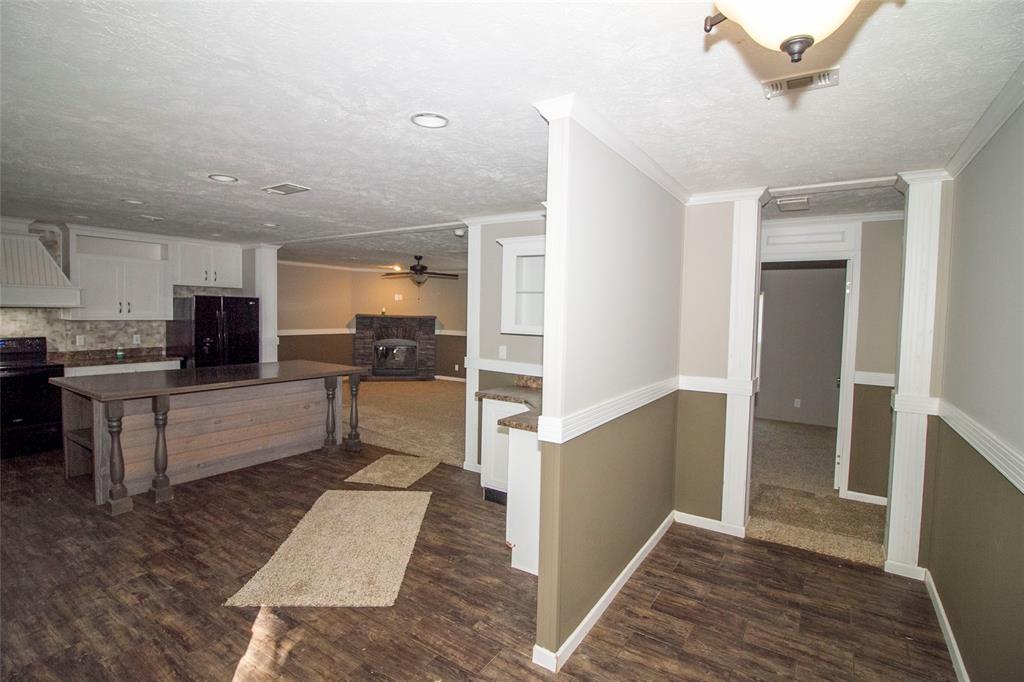 7572 Quitman Highway Quitman, LA 71268 - Photo 2 of 10 a large white kitchen with stainless steel appliances kitchen island granite countertop a refrigerator and a stove top oven