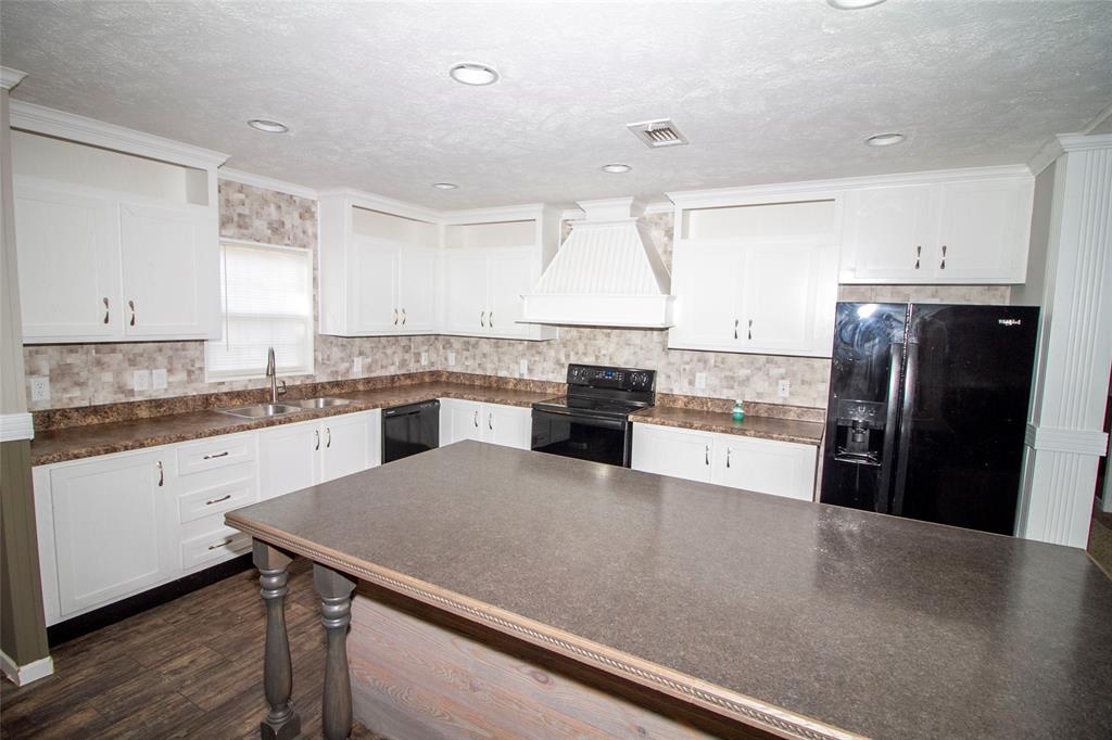 7572 Quitman Highway Quitman, LA 71268 - Photo 4 of 10 a kitchen with stainless steel appliances granite countertop a refrigerator a sink a stove and island