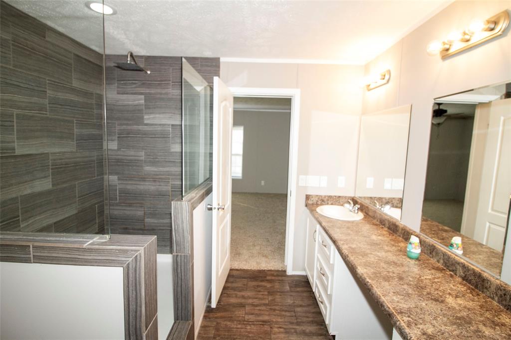 7572 Quitman Highway Quitman, LA 71268 - Photo 8 of 10 a bathroom with a granite countertop double vanity and a shower