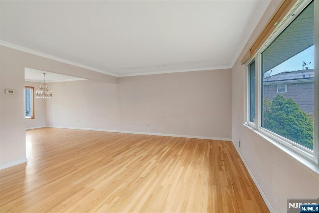 9 Hemlock Drive Paramus, NJ 07652 - Photo 11 of 35 a view of empty room with wooden floor and fan