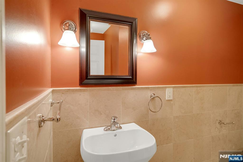 9 Hemlock Drive Paramus, NJ 07652 - Photo 15 of 35 a bathroom with a sink and a mirror