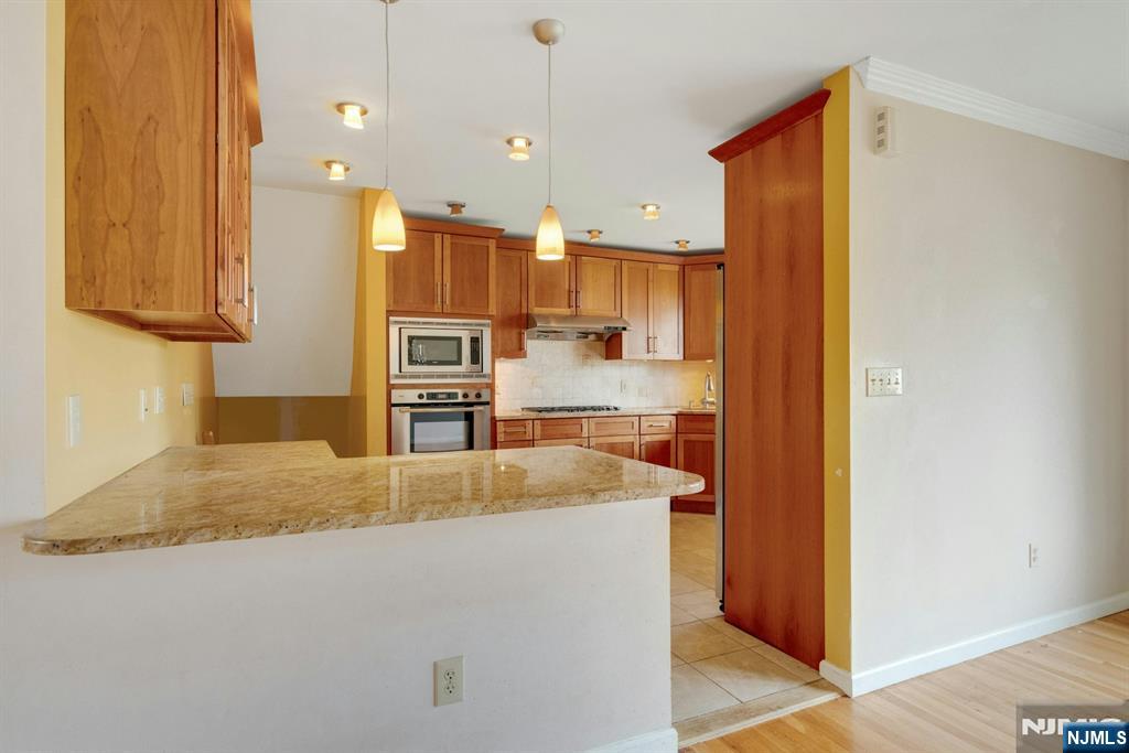 9 Hemlock Drive Paramus, NJ 07652 - Photo 19 of 35 a kitchen with kitchen island granite countertop a refrigerator and a sink